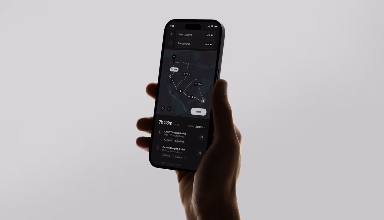 A hand holding a phone showing the EV Infinity charging app
